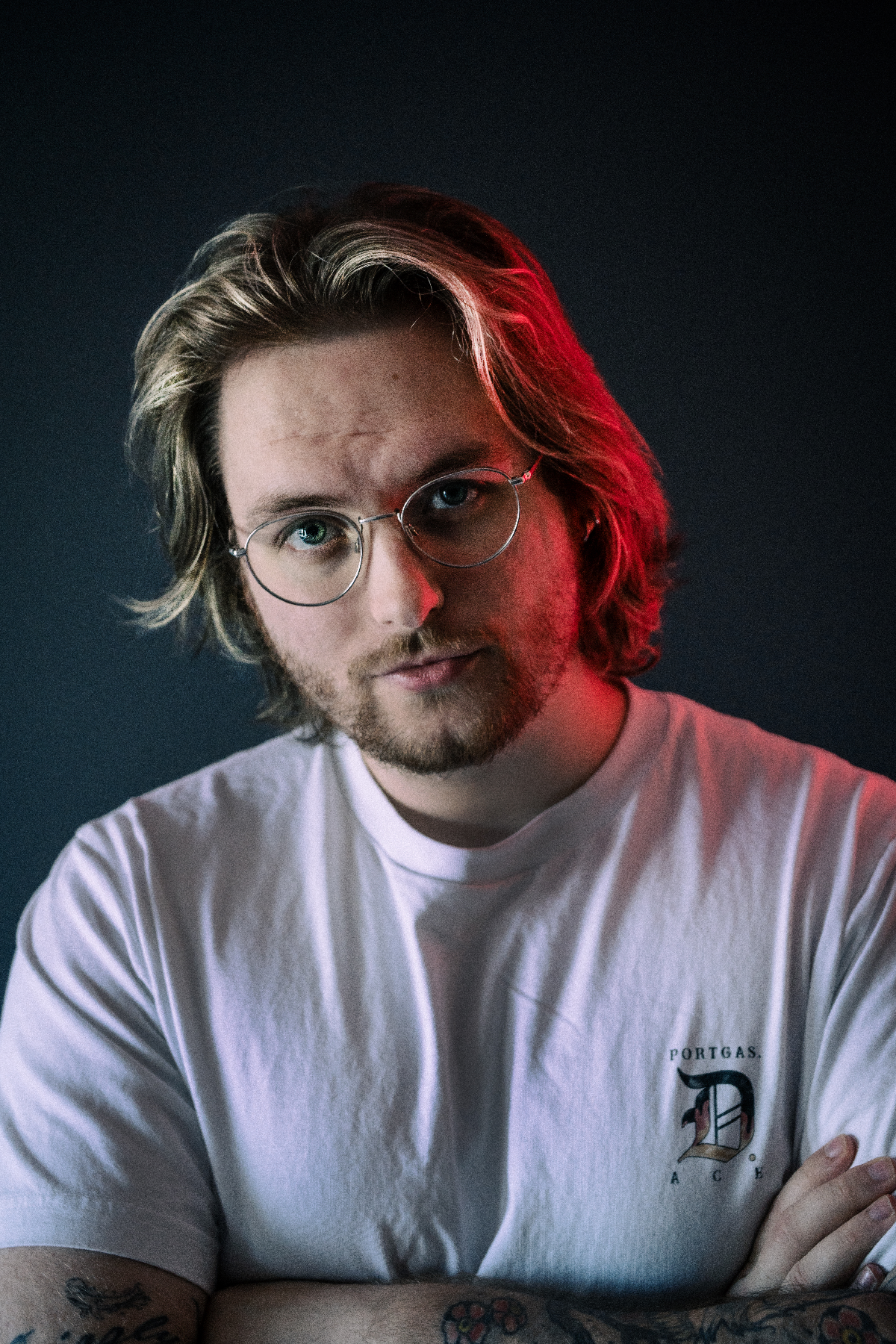 Nate Grizzly in a white tshirt side-light by a red light