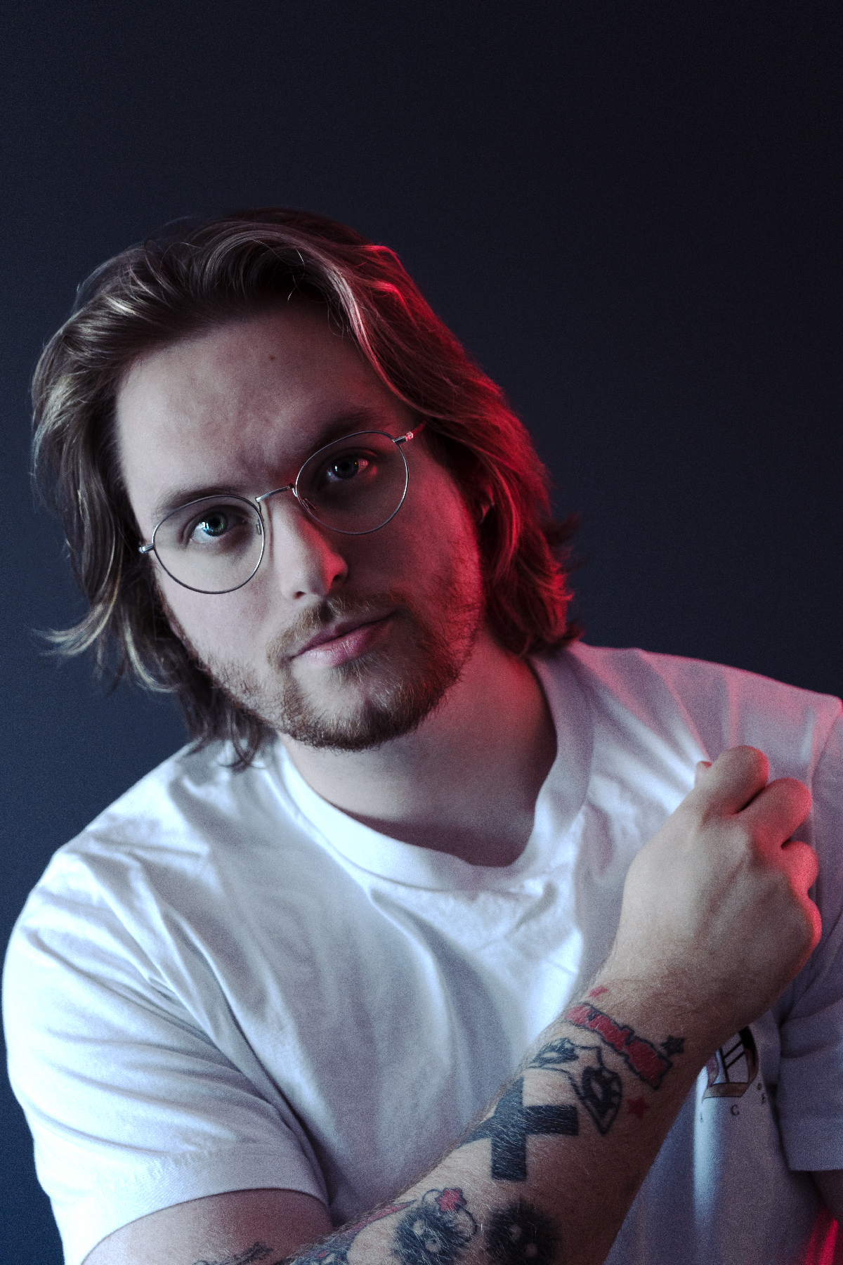 Nate Grizzly in a white tshirt side-light by a red light